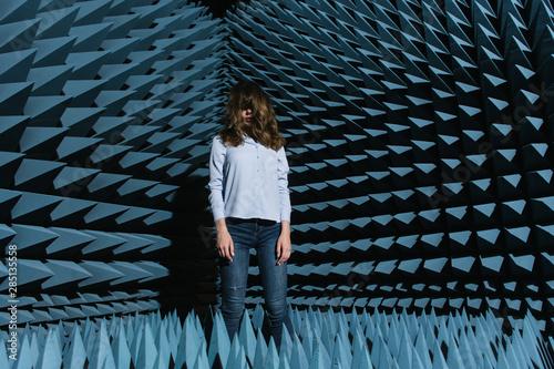 Woman in middle of sound room shaking head photo