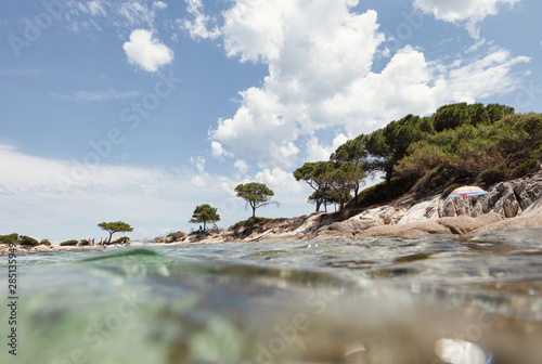 Picturesque view of rocky island and sea bottom on sunny summer day in Halkidiki, Greece photo