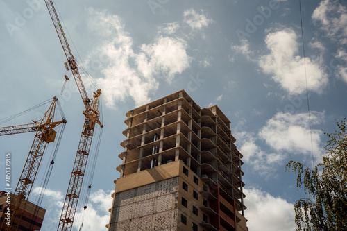 New residential complex under construction area with a developing infrastructure. house under construction. modern urban building under construction with a crane