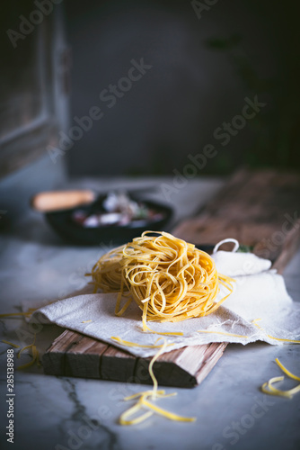 From above appetizing dry pasta on tablecloth on table photo