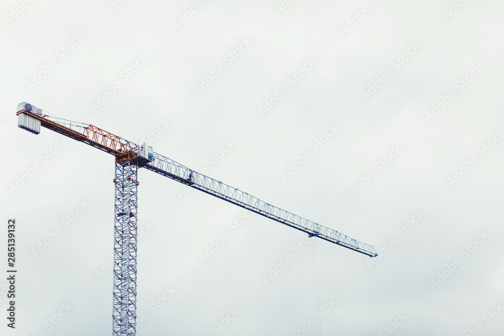hoisting crane on sky background. construction site hoisting crane on sky background. construction site