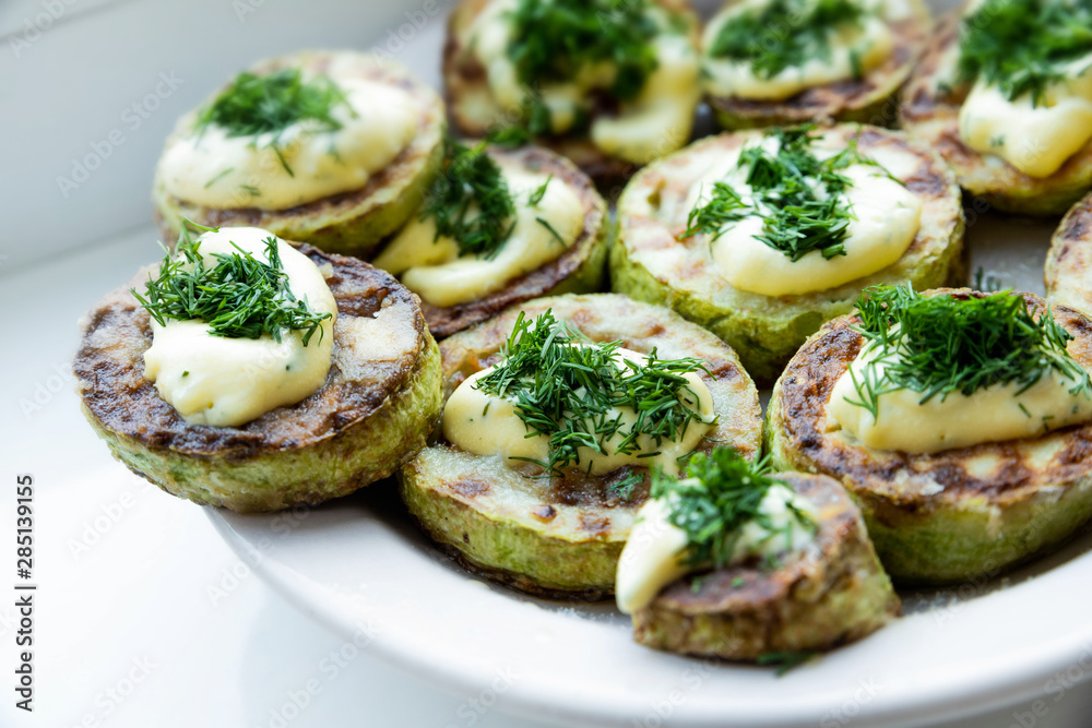 homemade zucchini fried with mayonnaise. On a white background homemade zucchini fried with mayonnaise. On a white background