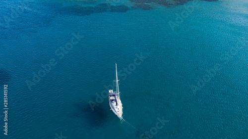 Aerial shot of a sailboat at blue color sea © ucarer
