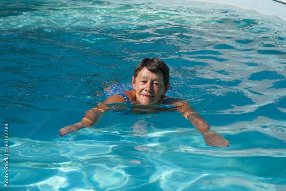 Senior woman happy in the swimming pool