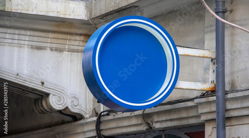 black round blank signboard hanging on wall.mockup signboard 3d rendering photo