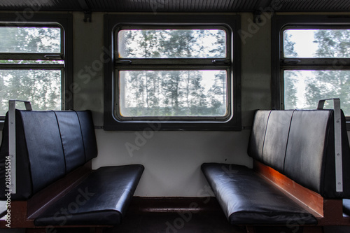 Empty seats inside passenger car of old electrical train
