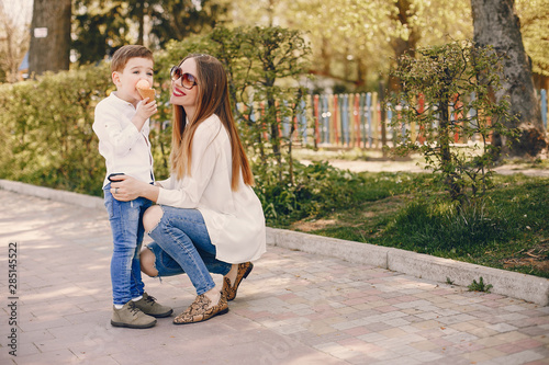 Family in a summer park. Mother in a white shirt. Cute little boy © hetmanstock2