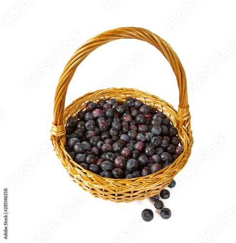 fresh blueberries in a basket isolated on white background