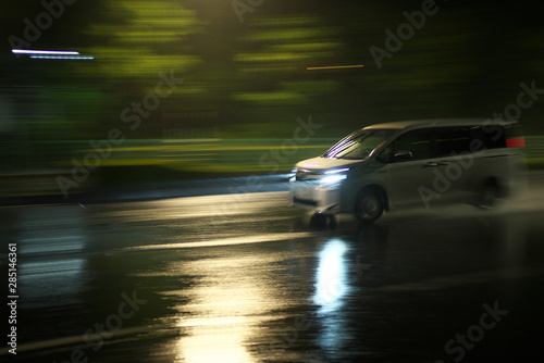 Tokyo,Japan-August 19, 2019: Panning of a car running in heavy rain