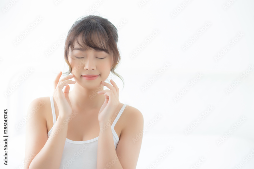 Portrait beautiful asian woman makeup of cosmetic, girl hand touch cheek and smile attractive, face beauty perfect with wellness in the bedroom at home with skin care and healthcare concept. Portrait beautiful asian woman makeup of cosmetic, girl hand touch cheek and smile attractive, face beauty perfect with wellness in the bedroom at home with skin care and healthcare concept.