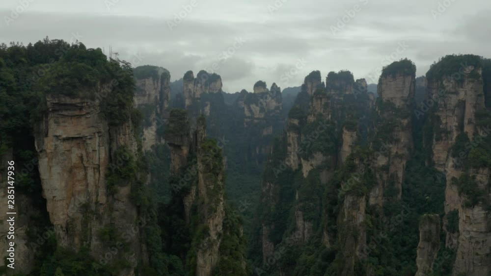 Aerial, drone shot of quartz sandstone pillar formations, in the Zhangjiajie national forest park, a UNESCO World Heritage Site, on a overcast day, in Hunan Province, china