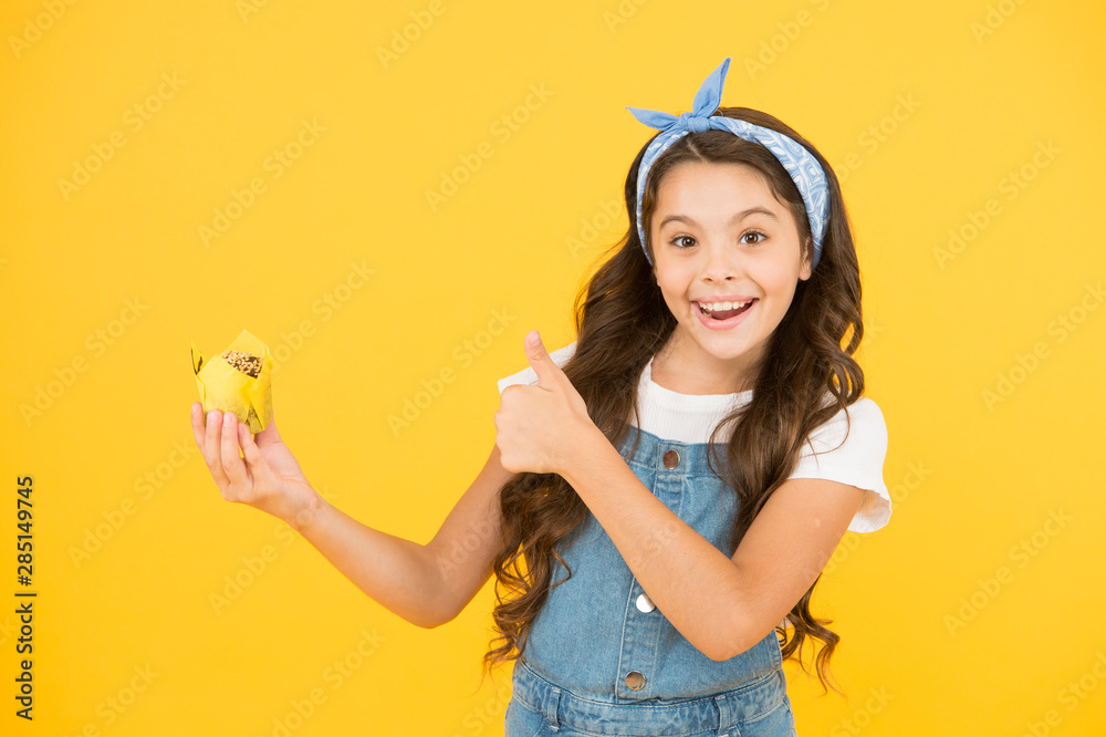 Homemade muffin. Bakery confectionery concept. Kid girl hold muffin. Gluten free recipe. Delicious cupcake. Little child with muffin on yellow background. Treat someone with sweets. Yummy cupcake Homemade muffin. Bakery confectionery concept. Kid girl hold muffin. Gluten free recipe. Delicious cupcake. Little child with muffin on yellow background. Treat someone with sweets. Yummy cupcake