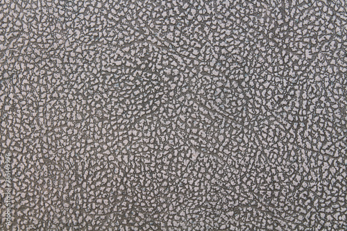 Leatherette. Old brown faux leather. Close-up. Background. Texture.