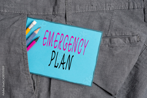 Conceptual hand writing showing Emergency Plan. Concept meaning procedures for handling sudden or unexpected situations Writing equipment and blue note paper in pocket of trousers