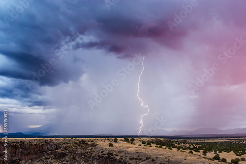 Thunderstorm with lightning strike and dramatic storm clouds