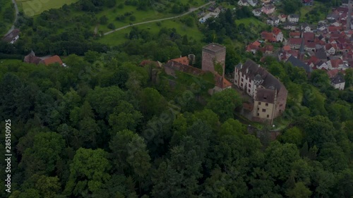 Aerial view of the  village and castle Gamburg in Germany.  Pan to the left around the castle with the village in the back. photo