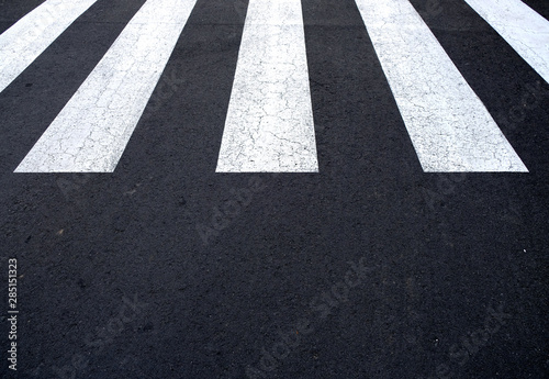 Zebra crossing painted on asphalt surface.