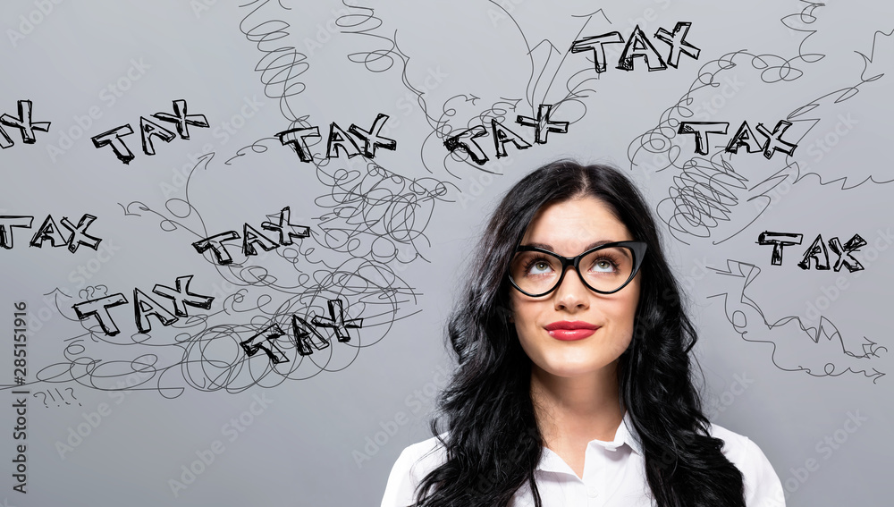 Fototapeta premium Tax problem theme with young businesswoman in a thoughtful face