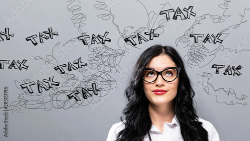 Tax problem theme with young businesswoman in a thoughtful face photo