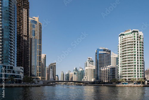 DUBAI, UAE - may 2019: View of modern skyscrapers shining in sunrise lights in Dubai Marina in Dubai, UAE.