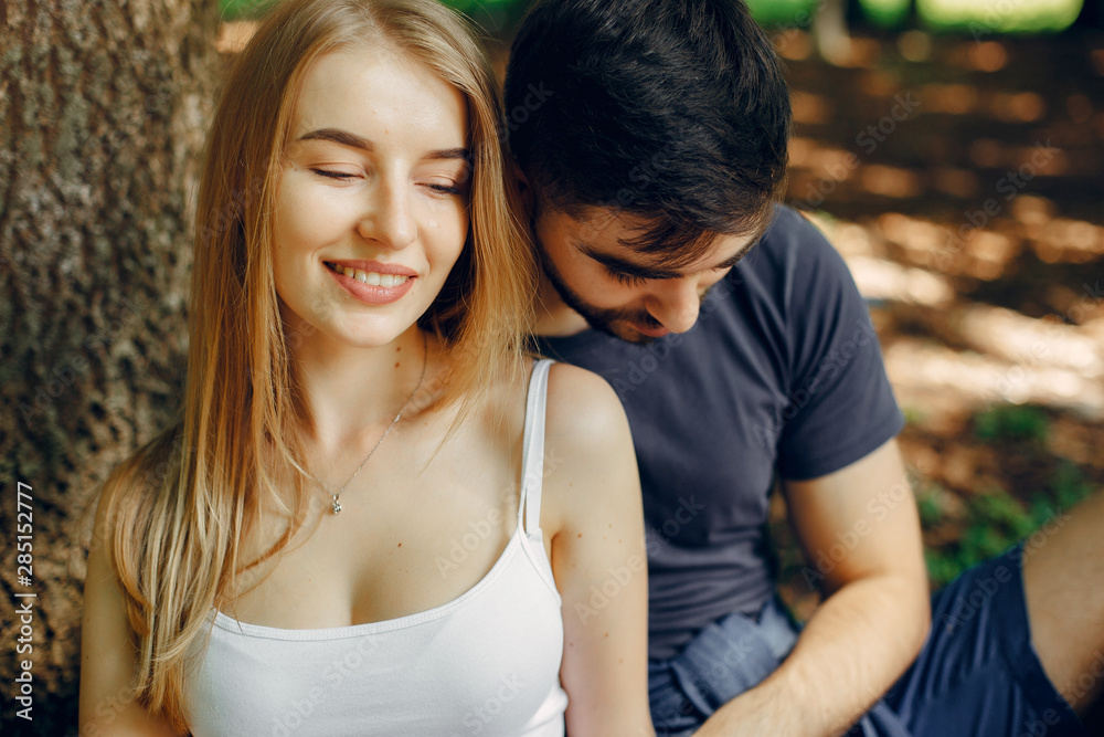 Couple in a forest. Beautiful blonde with her boyfriend