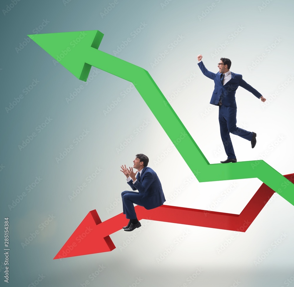Businessman with charts of growth and decline Businessman with charts of growth and decline
