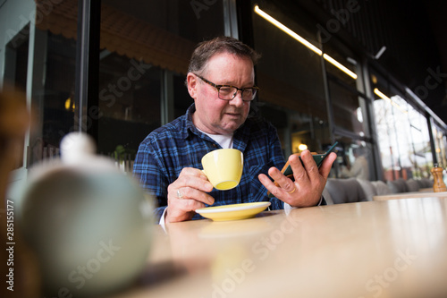 Senior Man Relaxing in a Coffee Shop photo