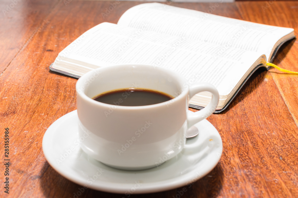 Pure coffee with cookies, bible and flowers in detail