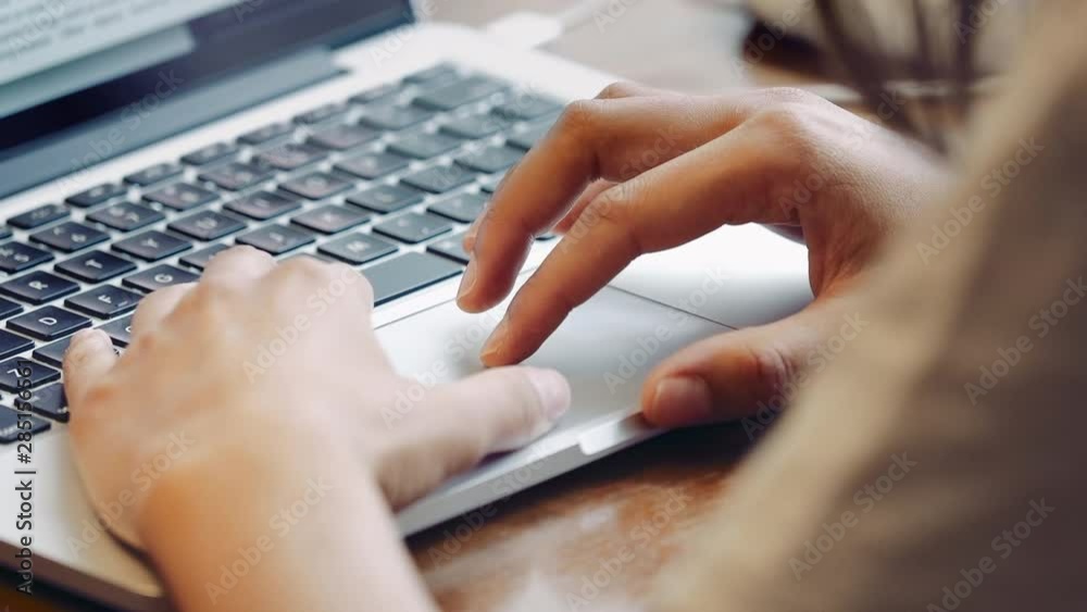 close up of female hands typing on keyboard at home