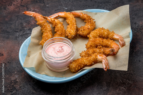 fried tempura shrimp on dark concrete rustic table photo