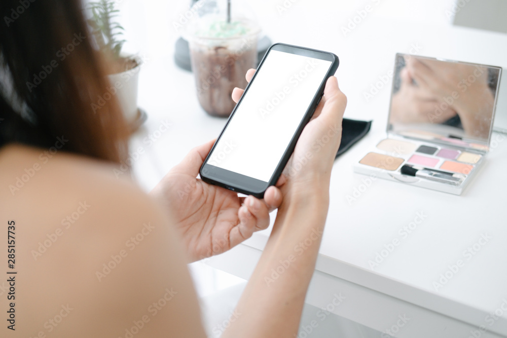 Mockup image of Beautiful woman shopping online with smartphone on online websites, mockup concept