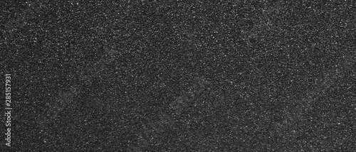 Panorama black sandpaper texture background. Panoramic dark black sandpaper texture surface photo