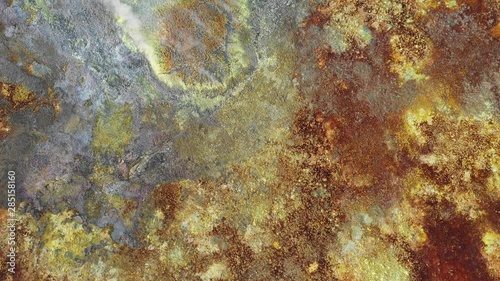 Overhead drone shot flying over steaming sulfuric crater of Dallol hydrothermal field, bizarre natural scenery and geology in Ethiopia Africa photo