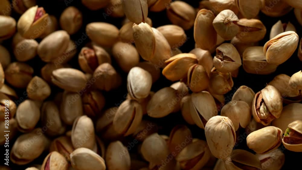 Super slow motion of flying pistachio nuts on black background. Filmed on high speed cinema camera, 1000 fps. Super slow motion of flying pistachio nuts on black background. Filmed on high speed cinema camera, 1000 fps.