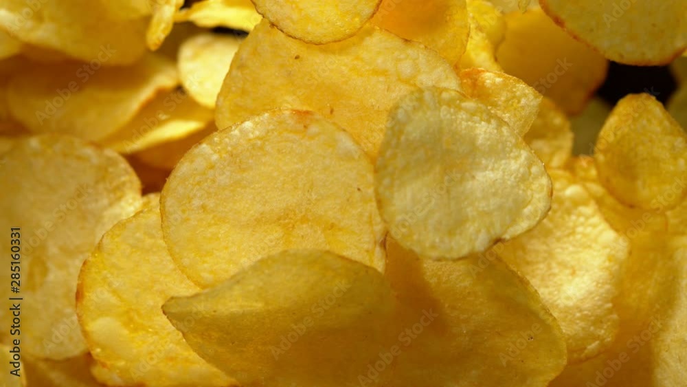 Super slow motion of flying fried potatoes chips on black background. Filmed on high speed cinema camera, 1000 fps. Super slow motion of flying fried potatoes chips on black background. Filmed on high speed cinema camera, 1000 fps.