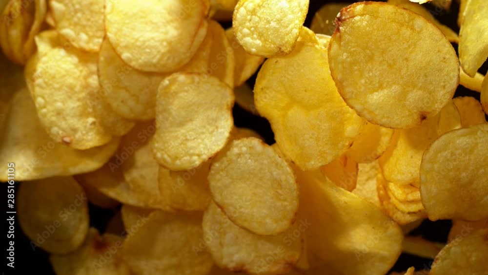 Super slow motion of flying fried potatoes chips on black background. Filmed on high speed cinema camera, 1000 fps. Super slow motion of flying fried potatoes chips on black background. Filmed on high speed cinema camera, 1000 fps.