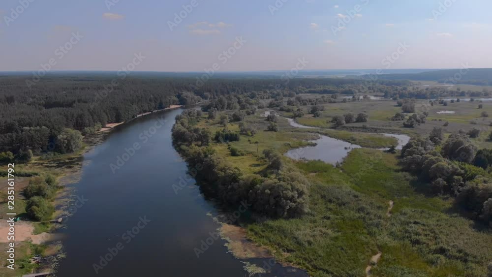 Revealing drone shot of a river and small lakes around it.