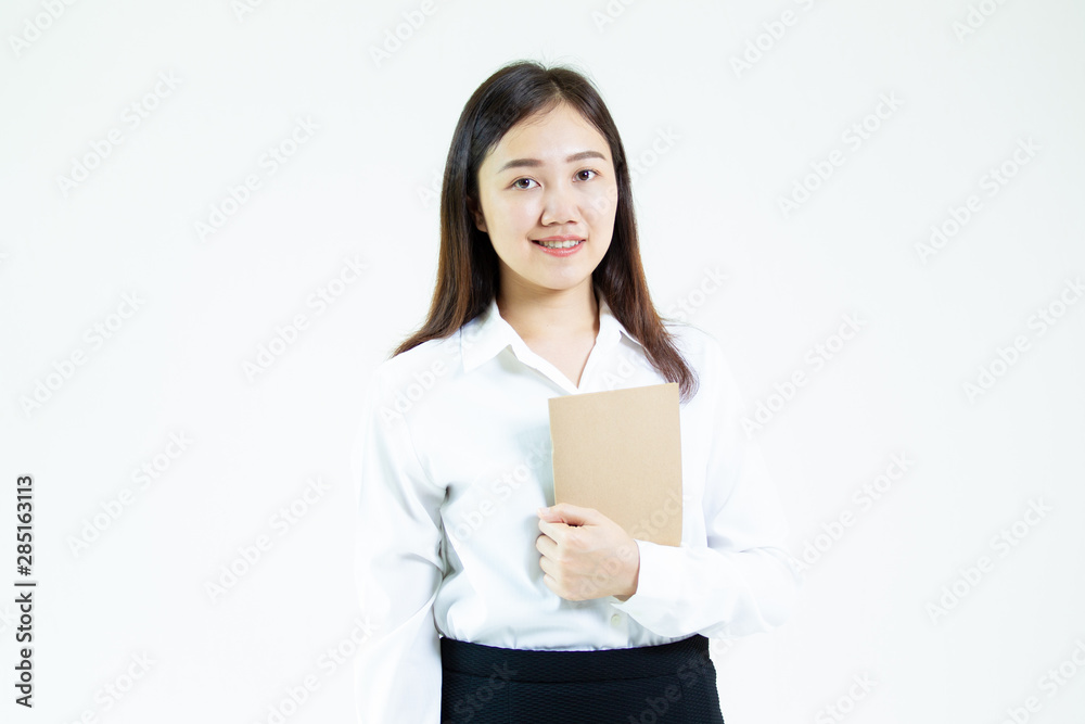 Portrait of a pretty young Asian student in formal white shirt holding a note book on hand on white background. Portrait of a pretty young Asian student in formal white shirt holding a note book on hand on white background.