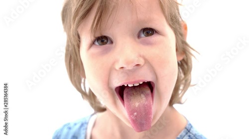 Cheerful little girl shows tongue, happy childhood concept