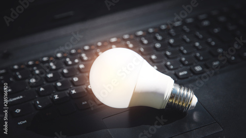 Light bulb on laptop keyboard. Idea, innovation, creativity
