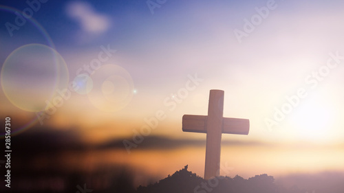 Obraz na płótnie Silhouette cross on mountain at sunset background