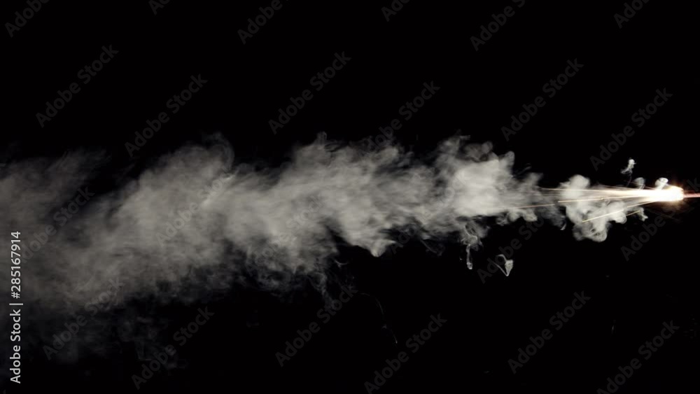 Firecracker burning and bursting smoke with sparks from side on black background Firecracker burning and bursting smoke with sparks from side on black background