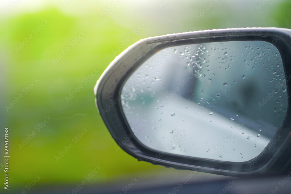 Rear view mirror car on green background in rainy day. Rear view mirror car on green background in rainy day.
