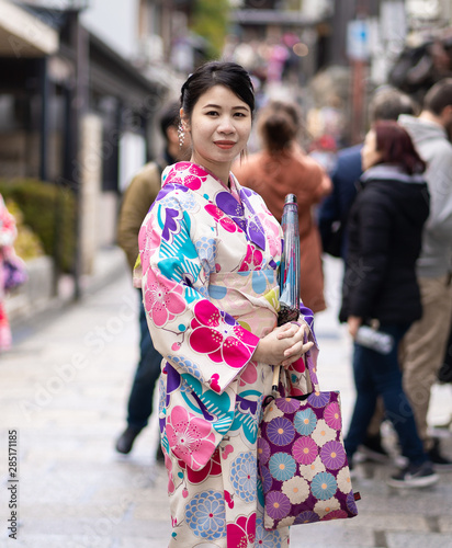Japanese Woman in Kimono walking on a street of Gion in Kyoto Japan.