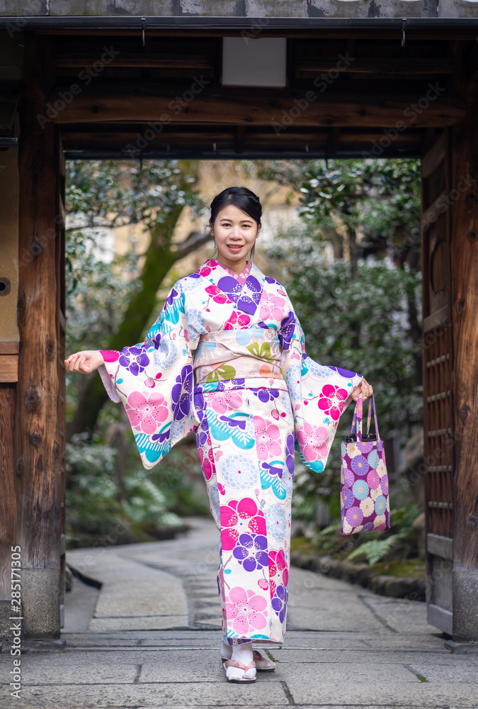 Japanese Women in Floral Printed Long Kimono in Gion House is an old wooden, traditional style at Gion Shijo Kyoto Japan. Japanese Women in Floral Printed Long Kimono in Gion House is an old wooden, traditional style at Gion Shijo Kyoto Japan.