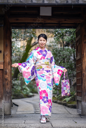 Japanese Women in Floral Printed Long Kimono in Gion House is an old wooden, traditional style at Gion Shijo Kyoto Japan.