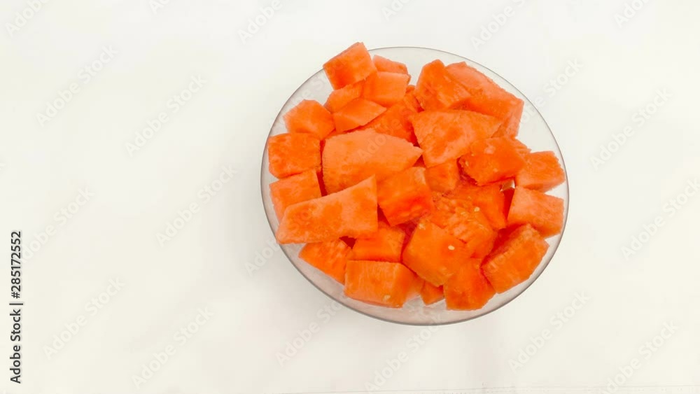 Overhead shot of juicy chunks of watermelon in the glass bowl on the white background in 4K. Overhead shot of juicy chunks of watermelon in the glass bowl on the white background in 4K.