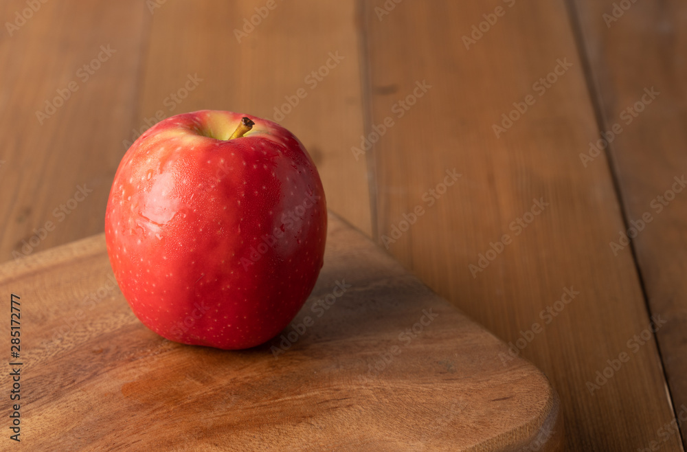 Fresh apple placed on a wooden table. Fresh apple placed on a wooden table.