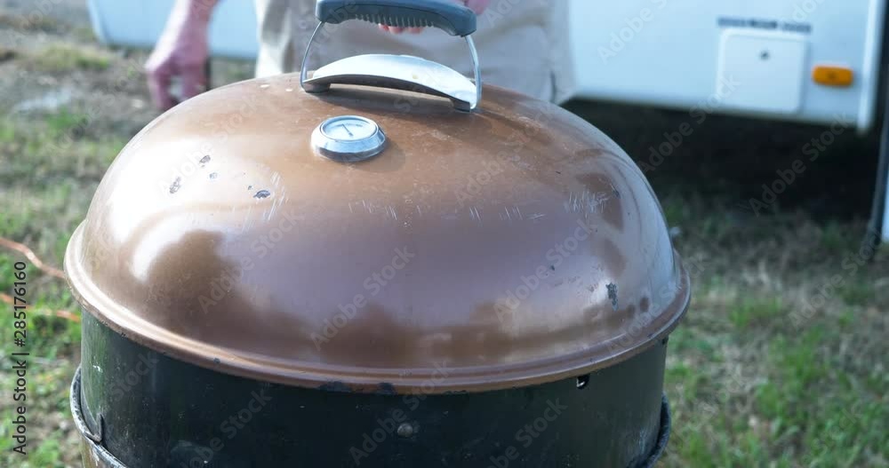 Chicken being cooked on a BBQ pit and the lid being placed over it. 4k Chicken being cooked on a BBQ pit and the lid being placed over it. 4k