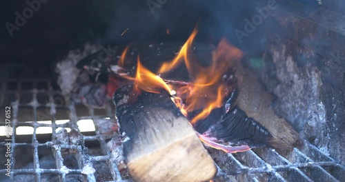 Wood logs on fire in an off set smoker for BBQ. 4k photo